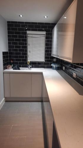 a kitchen with a sink and a counter top at Stylish house in Roydon in Roydon