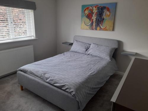 a bedroom with a bed in a room with a window at Stylish house in Roydon in Roydon