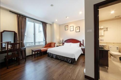 a hotel room with a bed and a bathroom at A25 Hotel - 15 Trần Quốc Toản in Hanoi