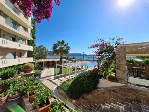 a view of a resort with a pool and flowers at Marmari Bay Hotel in Marmarion
