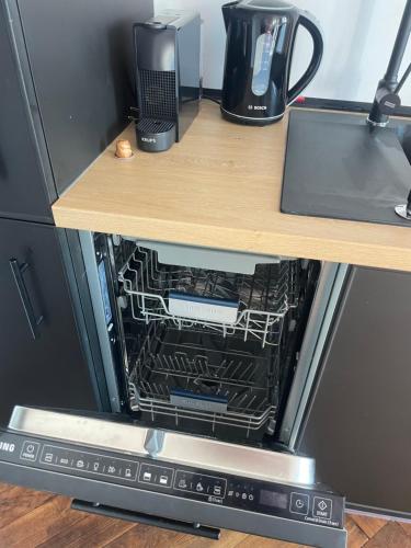 an open microwave oven sitting on top of a table at Apartamenty Warszawska in Toruń