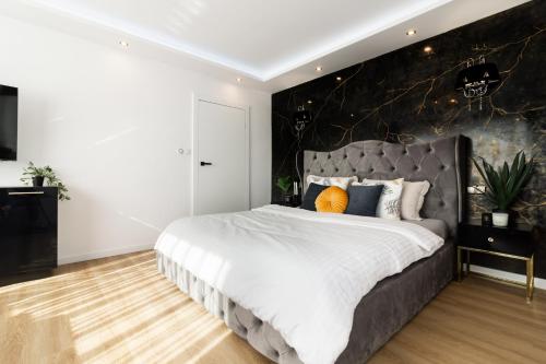 a bedroom with a large bed with a large headboard at HouseCube, Bar , prywatne Kino, Bilard , Luxus in Wrocław