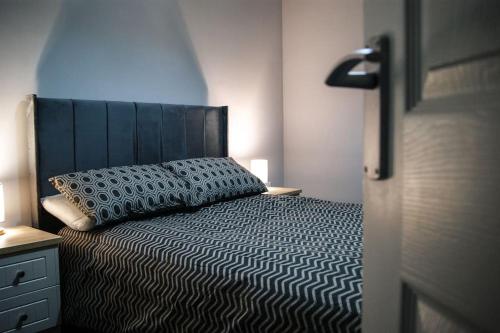 a bedroom with a bed with a pillow on it at Town Centre 2 Bedroom Apartment in Lincolnshire