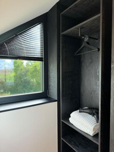a bedroom with a window and a shelf with a mattress at Durbuy Insolite - Panoramic Escape in Durbuy