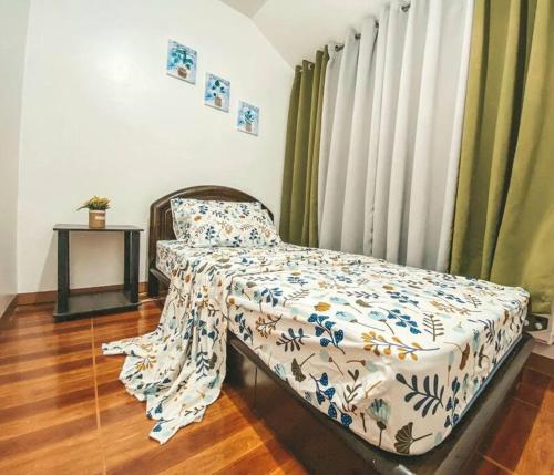 a bedroom with a bed and a window with curtains at TRP4 - Rustic Styled 2BR Townhouse in DecaClark Angeles in Tacondo