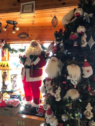 a christmas tree with santa claus decorations on it at Victory Gardens in Union Pier
