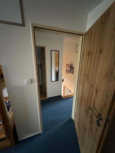 a hallway with a door leading into a room at Čistá v Krkonoších - Chata Belmonda in Cerny Dul