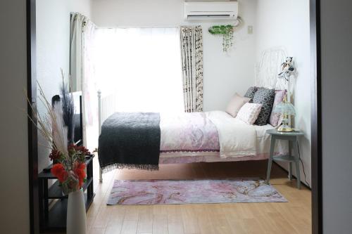 a bedroom with a bed and a window at Housegreen201 in Tokyo