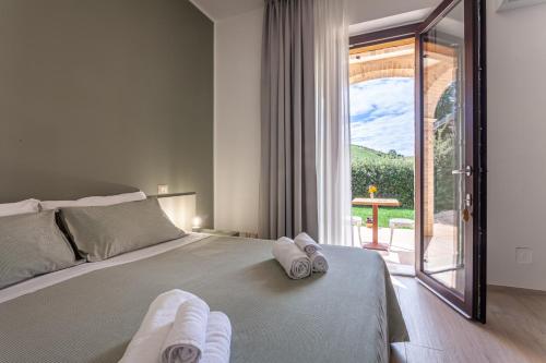 a bedroom with a bed with towels on it at Agriturismo San Nicolino in Offida