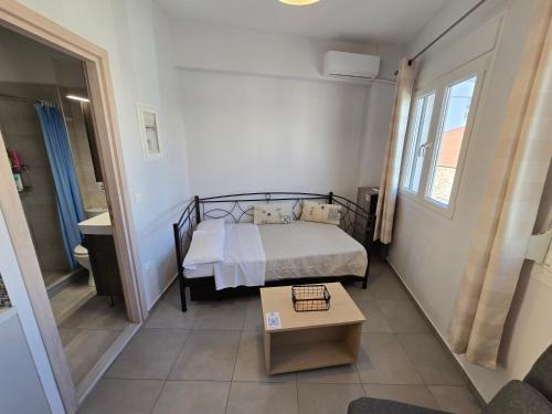a small bedroom with a bed and a table at Αργέντη in Chios