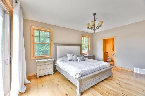 a bedroom with a bed and a window at Luxurious Home & Amazing Views in Windham