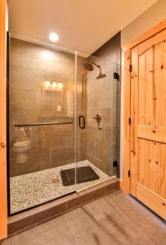 a shower with a glass door in a bathroom at Luxurious Home & Amazing Views in Windham