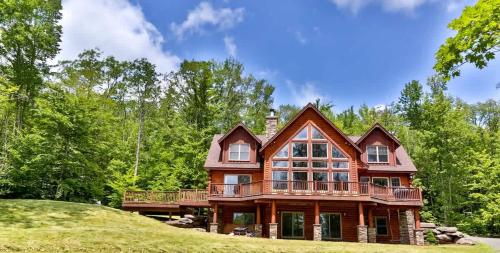 a large wooden house on top of a hill at Luxurious Home & Amazing Views in Windham