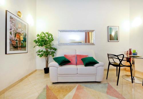 a living room with a white couch and a table at Mario Suite Spagna in Rome