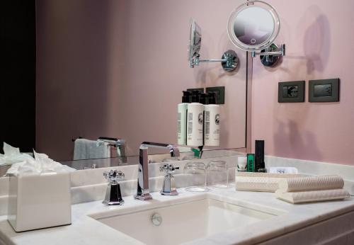 a bathroom with a white sink and a mirror at Hotel Number Nine in Florence