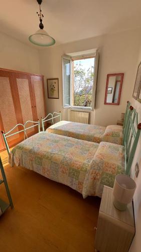 a bedroom with a bed and a window at La casa di Perla in Perugia