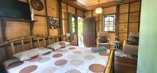 a bedroom with a bed in a room with wooden walls at Phang Nga Bay Khanittha Homestay in Ban Khiam