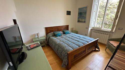 a bedroom with a bed with a blue comforter at La casa di Perla in Perugia