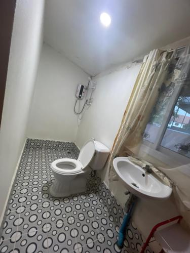 a bathroom with a toilet and a sink at Outland Hostel Vang Vieng in Vang Vieng