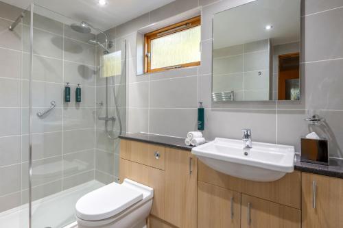 a bathroom with a sink and a toilet and a shower at The Lodges at Craigendarroch Country Club in Ballater