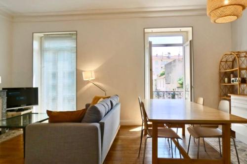 un salon avec une table et un canapé dans l'établissement Bel appartement hausmannien à Montpellier, à Montpellier
