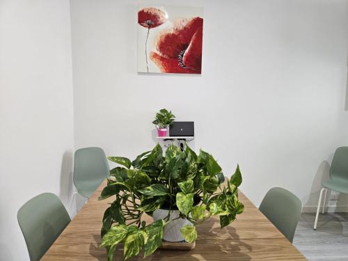 a dining room with a table with plants on it at Be Your Home - Guest House Il Ferroviere in Civitavecchia