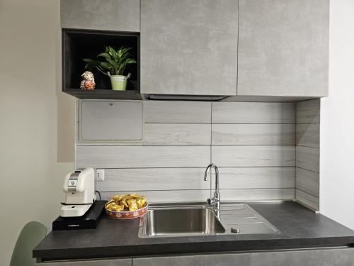 a kitchen counter with a sink and a mixer at Be Your Home - Guest House Il Ferroviere in Civitavecchia