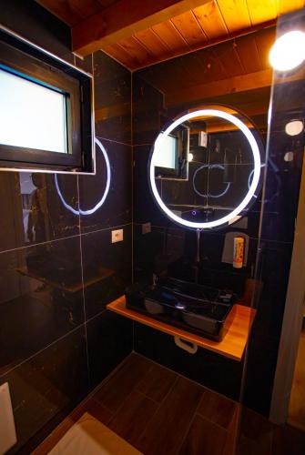 a bathroom with a mirror and a sink at Hotel & Restorant Flamuri in Lushnjë