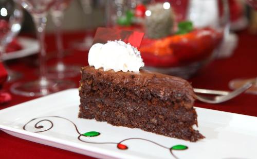 a piece of chocolate cake on a plate on a table at Hotel Zenica in Zenica
