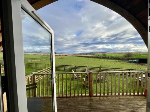 a view from a porch with a view of a pasture at Sunnybank by Wigwam Holidays in Reston
