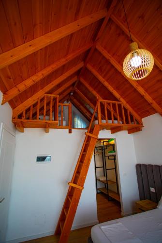 a wooden ladder in a room with a ceiling at Hotel & Restorant Flamuri in Lushnjë