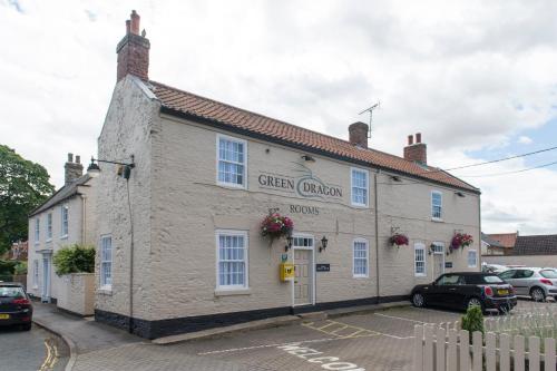 a white building with a sign on the side of it at Green Dragon, Welton by Marston's Inns in South Cave