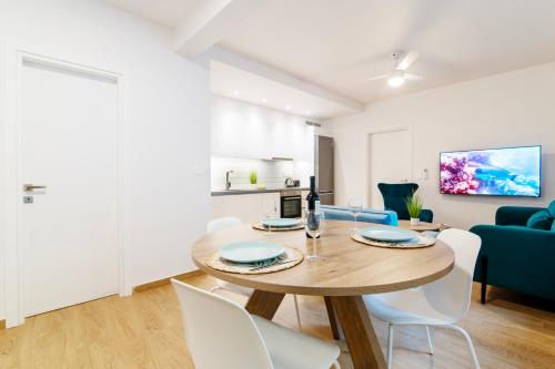 a dining room and living room with a table and chairs at Lighthouse Kipseli in Athens