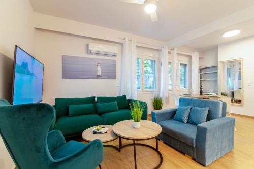 a living room with a couch and two chairs and a table at Lighthouse Kipseli in Athens