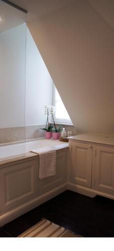 a bathroom with a window and a bath tub at Guest house La Maison Chantecler in Brussels