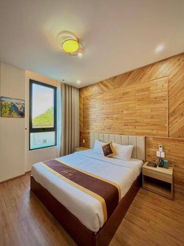 a bedroom with a large bed and a window at LuckyStar Hotel in Pleiku