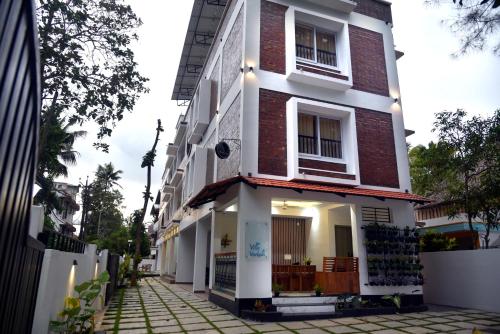 a building with white and red brick at Villa Varkala in Varkala