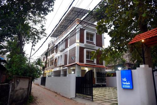 a building with a sign in front of it at Villa Varkala in Varkala