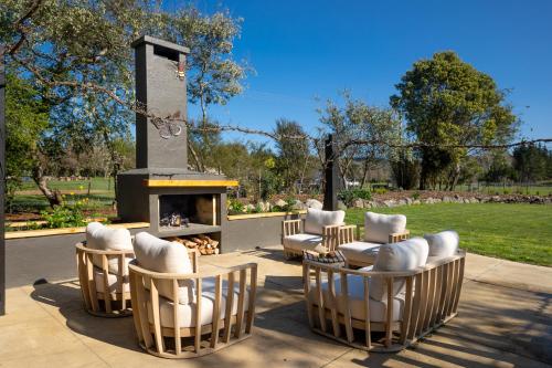 a group of chairs and a fire place at Peaceful Nelson getaway - spa pool, space & views in Nelson