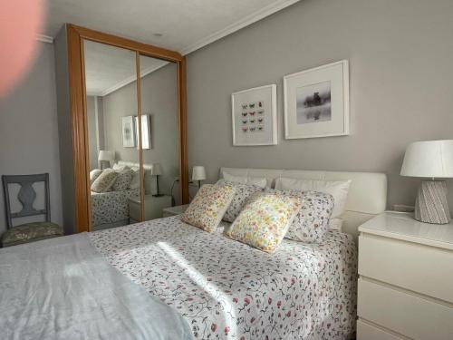 a bedroom with a bed and a large mirror at Apartamento de Toró in Llanes