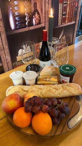 a plate of fruit and bread on a table at Converted Barn in Saint-Merd-la-Breuille