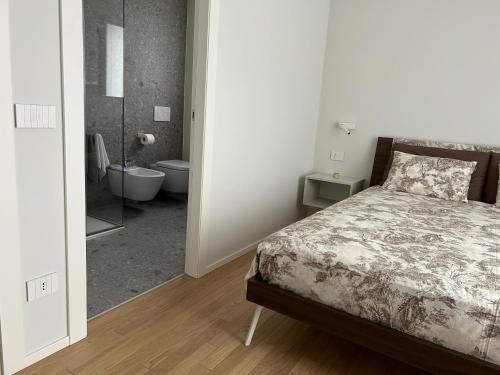a bedroom with a bed and a bathroom with a shower at ALBENZA GREEN VILLAGE bed and breakfast in Almenno San Bartolomeo