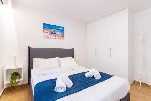 a bedroom with a large bed with towels on it at Lighthouse Kipseli in Athens