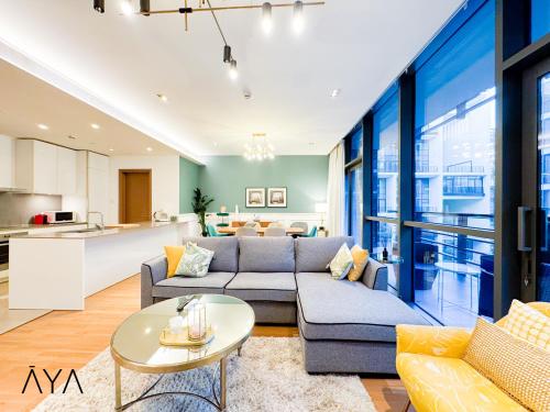 a living room with a couch and a table at Luxury Apartment with Pool, Patio & Gym in City Walk By ĀYA Boutique in Dubai