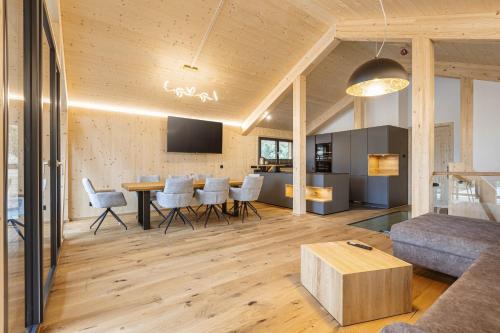 a living room with a table and a couch at Naturchalets Turracher Höhe by ALPS RESORTS in Turracher Hohe