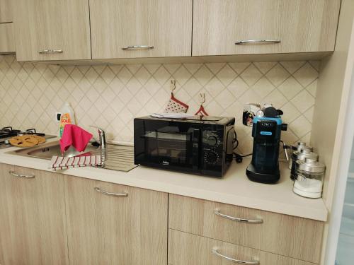 a kitchen counter with a microwave on top of it at I 4 bimbi in Borgomale
