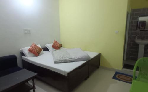 a small bed with pillows on it in a room at Himalayan Villa by StayApart in Phata