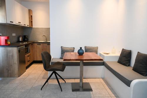 a kitchen with a table and a couch in a room at Glaronisia Hotel in Pollonia