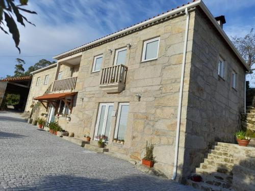 a stone building with windows and balconies on it at Alojamento São Lourenço in Viseu