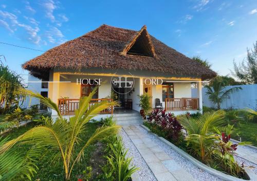 a hotel in a resort with a thatched roof at Villa Changarawe in Mdudu Mkubwa